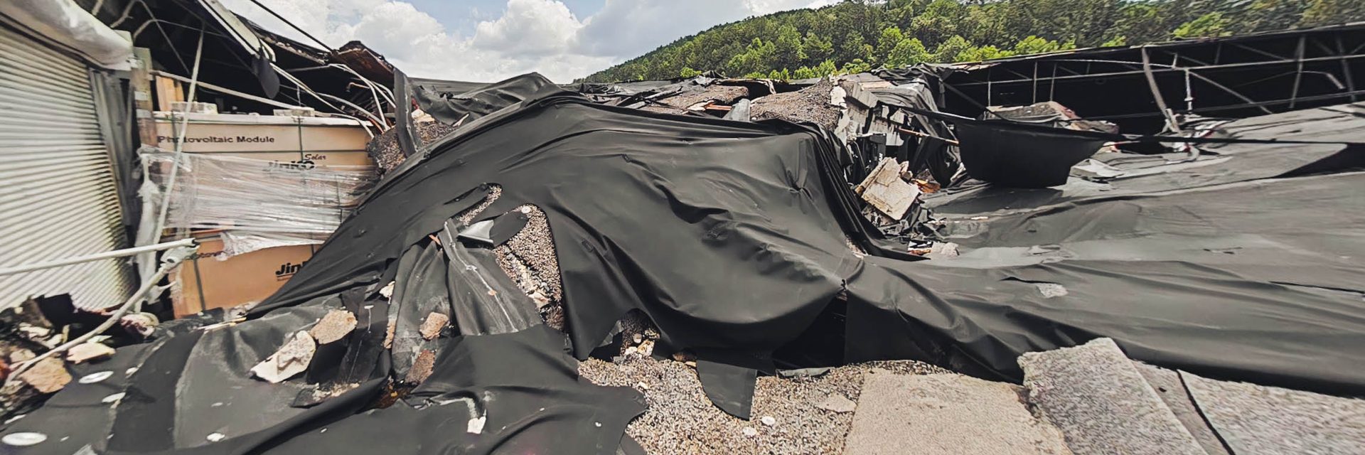 Temporary covering over the collapsed section of the warehouse roof