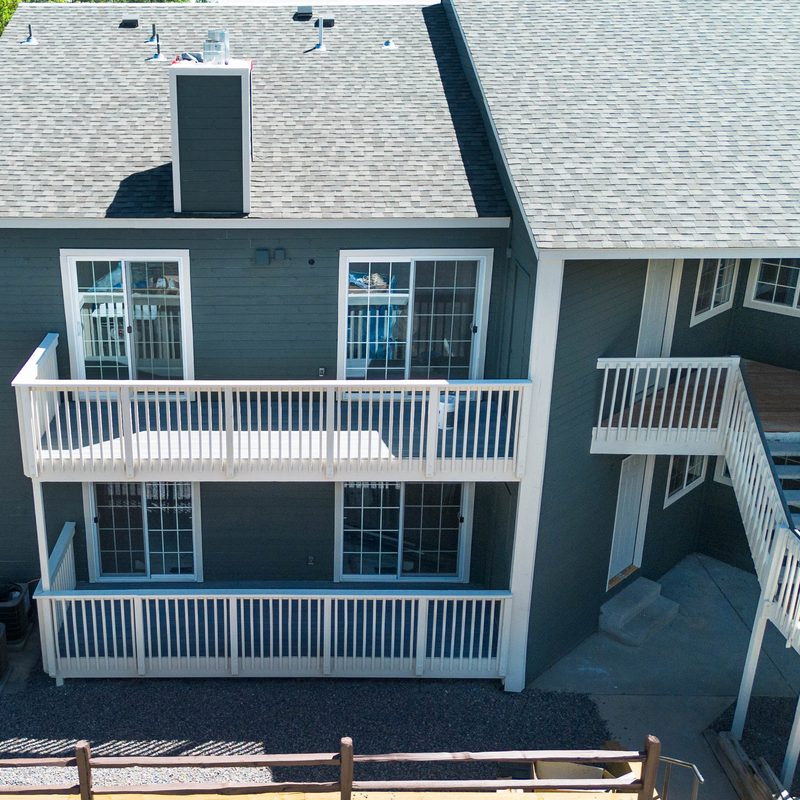 The same building restored, with new siding, balconies and railings