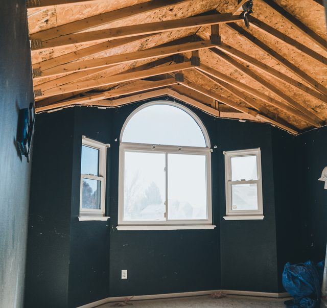 Vaulted ceiling framing above the arched front window
