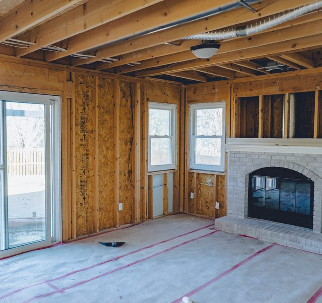 Living room framing around the fireplace with radiant heat lines run
