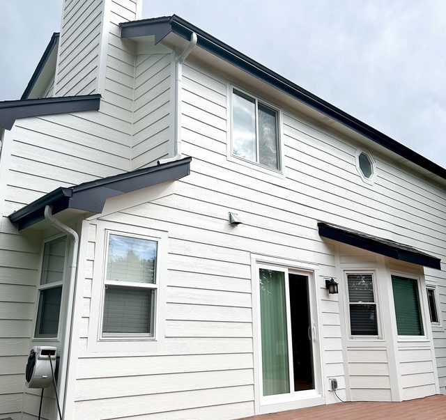 Finished rear elevation with new siding and a rebuilt deck