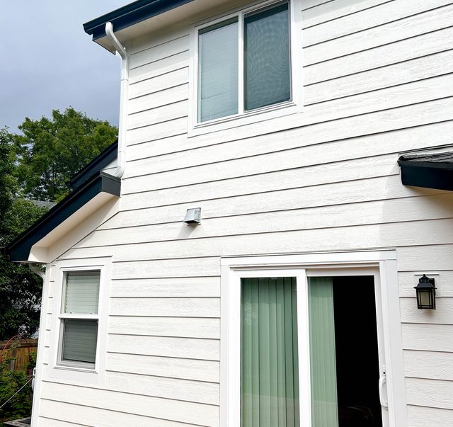Completed elevation with new siding and windows in place