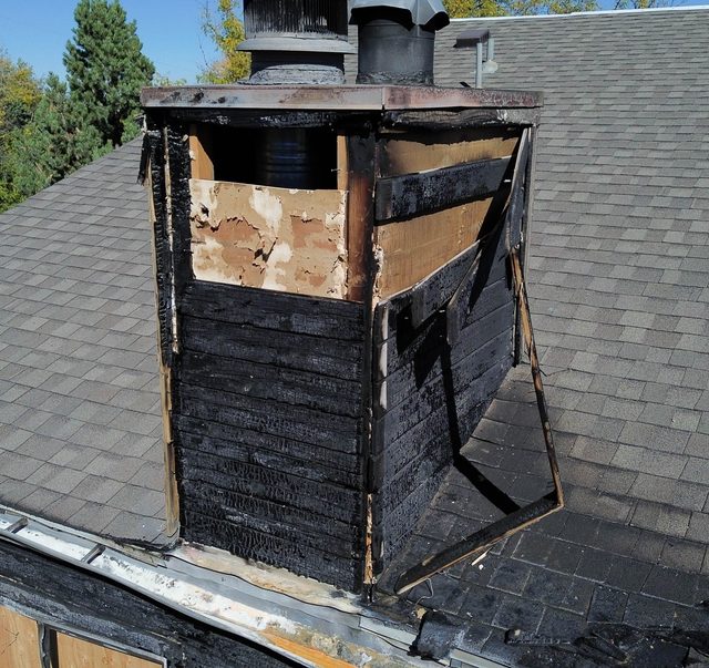 Close aerial of the burnt-through roof and chimney
