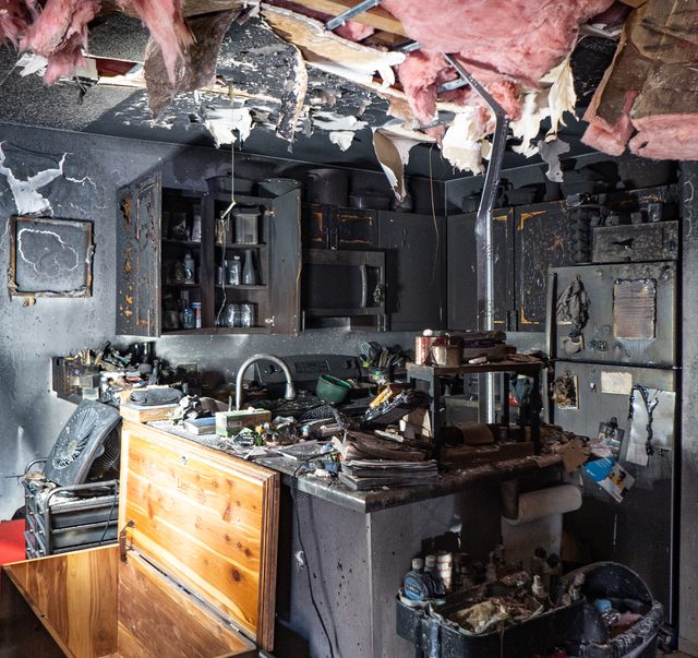 Gutted kitchen interior, cabinets and ceiling burnt out