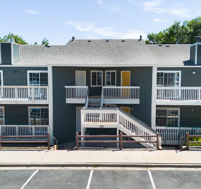 The restored building from the front, new siding and balconies