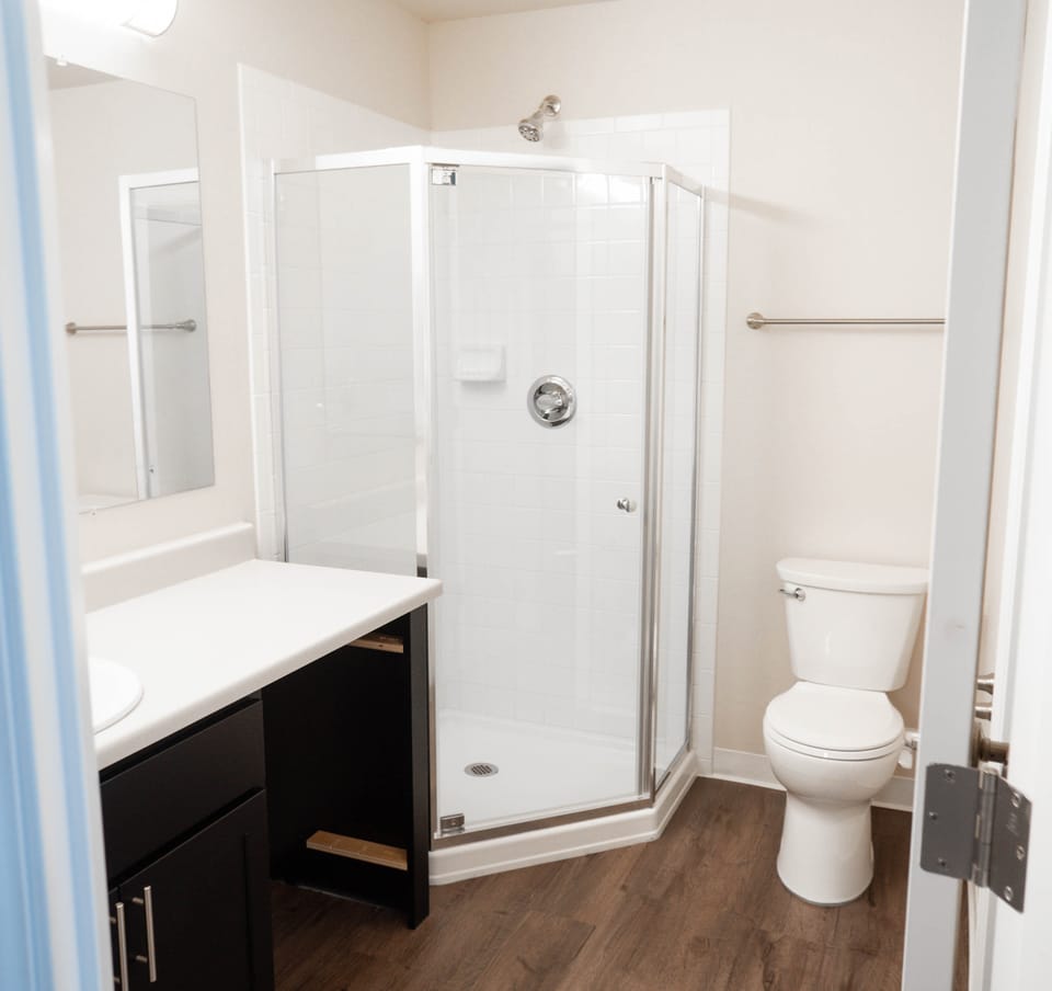 Restored bathroom with a new shower enclosure, vanity and flooring