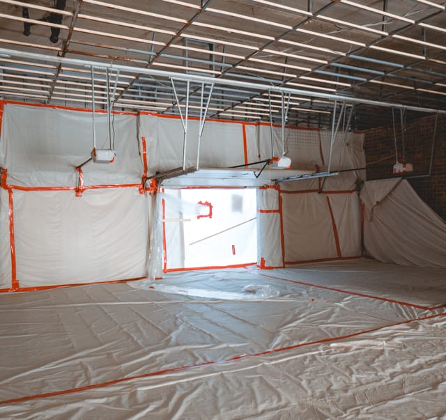 Containment and drying ducting run through the parking area beneath the building