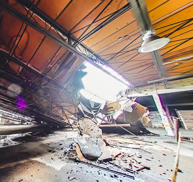Daylight through the collapsed bay, with the surrounding structure intact